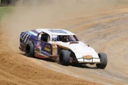 Drift around the dirt track driving a race car at St. Louis.